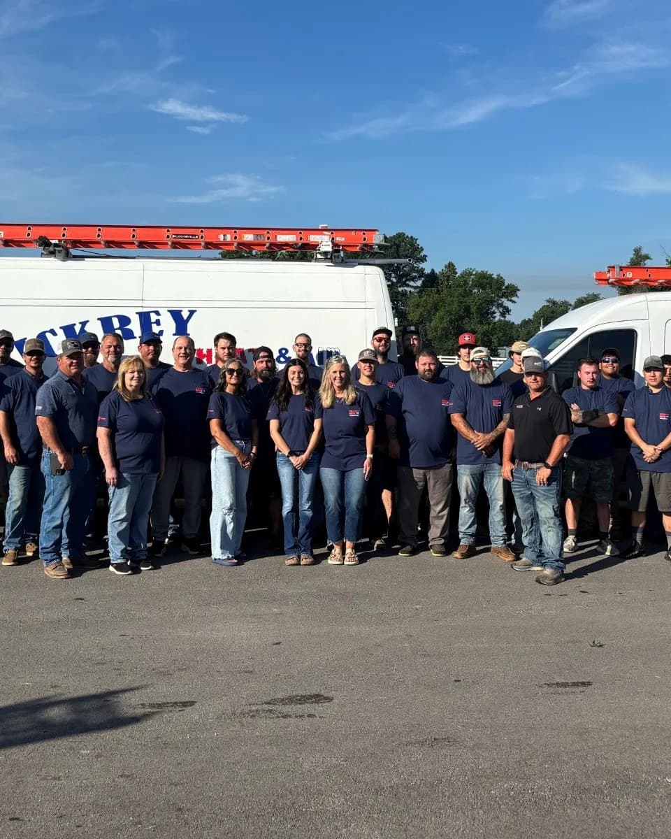 The Vickrey Heat & Air crew lined up in front of two company vans